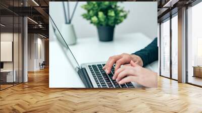 Close-up image of female person using laptop. Wall mural