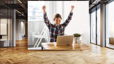 Excited casual entrepreneur girl reading good news Wall mural