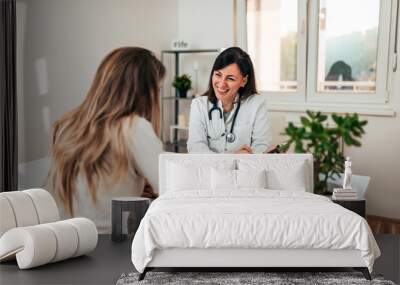 Female specialist explaining diagnosis to her patient. Wall mural