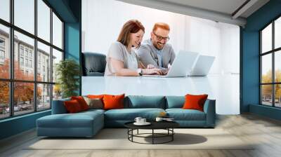 Group of confident business partners working with laptop in office Wall mural