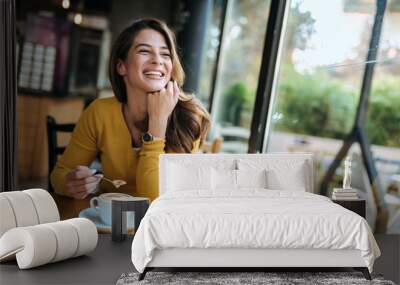 Happy woman drinking coffee at the cafe. Wall mural