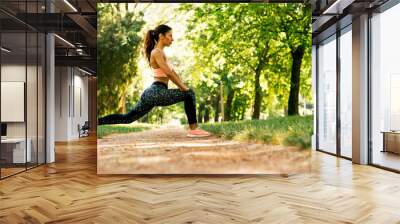 Healthy young woman stretching before fitness and exercise Wall mural