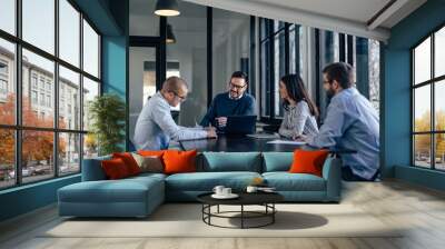 joyful caucasian colleagues, attending a company meeting, in the conference room. Wall mural