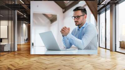 Portrait of a confident businessman with laptop Wall mural