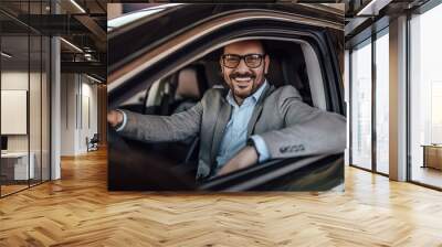 Portrait of a happy man, sitting in a car, holding a hand on a s Wall mural