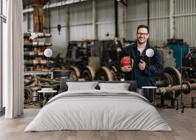 Portrait of a positive handsome train factory worker. Wall mural