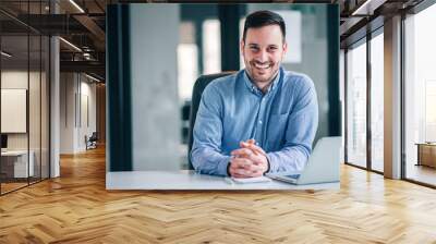 Portrait of a smiling entrepreneur or businessman at office desk. Wall mural