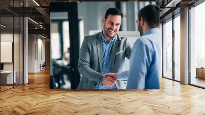 Portrait of cheerful young manager handshake with new employee. Wall mural