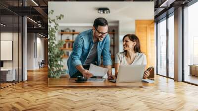 Portrait of successful smiling small business owners at cozy office. Wall mural