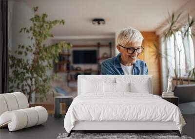 Senior woman, doing her taxes on time. Wall mural