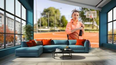 Sporty girl, looking at camera, sitting in a wheelchair, disability. Wall mural