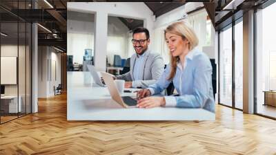 Two coworkers having fun while working. Close-up. Wall mural