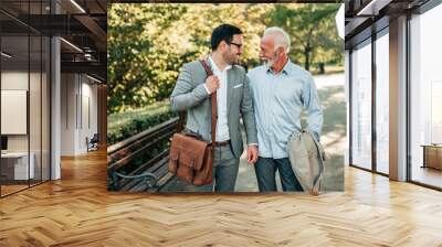 Two elegant men walking in the park. Wall mural