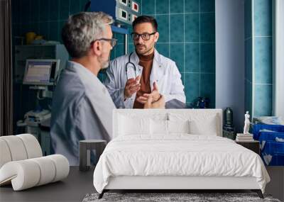 Two male doctors using tablet and discussed something in the hospital. Wall mural