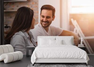 Young happy couple talking together sitting on the floor. Lens f Wall mural