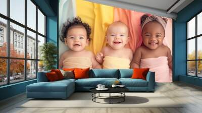 Cheerful babies of different ethnicities in diversity photo shoot on soft color background. Wall mural