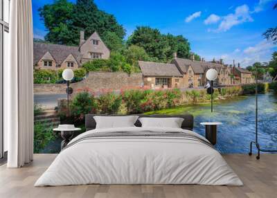 BIBURY, ENGLAND, UK - JULY 9, 2014: Arlington Row traditional Cotswold stone cottages in Gloucestershire on JULY 9, 2014, England. Bibury it the most depicted village in the world. Wall mural