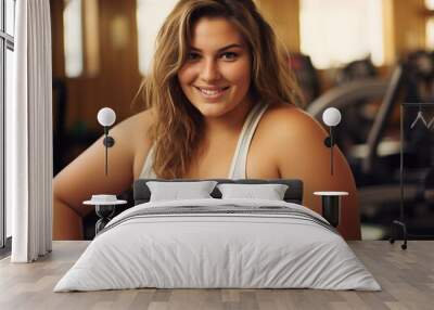 Smiling plus size young woman working out in gym Wall mural