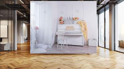 White interior of a photo studio with an old upright piano in the center Wall mural