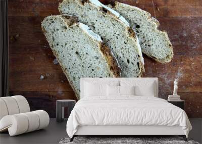 Loaf of sliced whole grain bread on wood bread board Wall mural