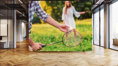 Couple playing badminton in the park. Sport, recreation, lifestyle, love concept Wall mural