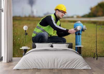 Safety first. Worker checking valves on the fuel supply systems. Concept of industry Wall mural