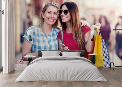 Shopping time. Young women shopping together. Consumerism, shopping, lifestyle Wall mural