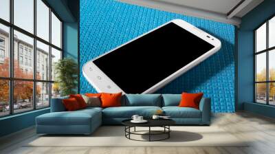 White smartphone on a blue background. Black screen Wall mural