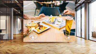 glass of beer and wine on the table eating food on the terrace - Two girls having lunch together in a restaurant Wall mural