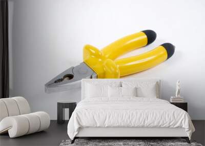 Yellow pliers on white background Wall mural