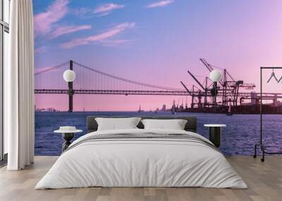 Pink purple sky over the Bay of Lisbon, port and bridge, marine industrial landscape Wall mural