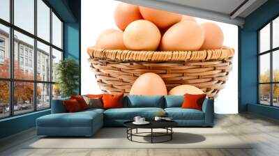 Eggs in basket isolated on white background Wall mural