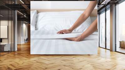 Hand set up white bed sheet in room Wall mural