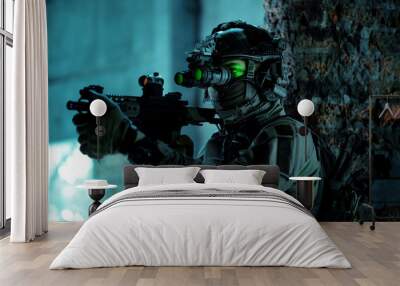 Man in uniform with machine gun and turned on night vision device inside broken building. Airsoft soldier with green light on face in night building Wall mural