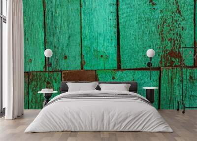 Old rusty wood wall from two rows of planks, painted green with spots of first wood layer. Wall mural