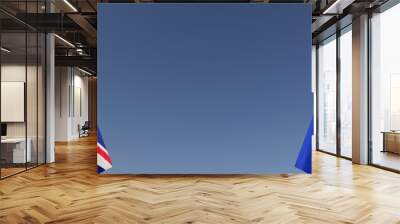 Flags of Great Britain and EU on flagpoles on sides. Flags on a blue background. Place for text. England, London. The United Kingdom. European Union. Commonwealth. 3D illustration. Wall mural