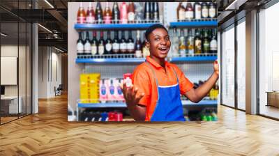 shot of surprised young handsome black shop owner holding mobile phone and smiling looking at camera Wall mural