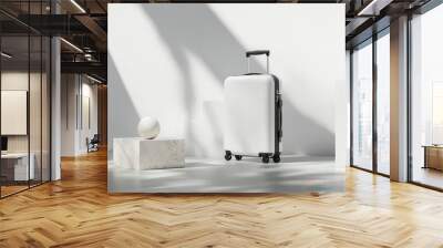 A minimalist scene featuring a white suitcase and a sphere on a pedestal. Wall mural