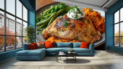 A plate featuring roasted chicken, mashed sweet potatoes, green beans, and garnished with herbs. Wall mural