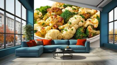 A plate of roasted cauliflower and broccoli garnished with herbs. Wall mural