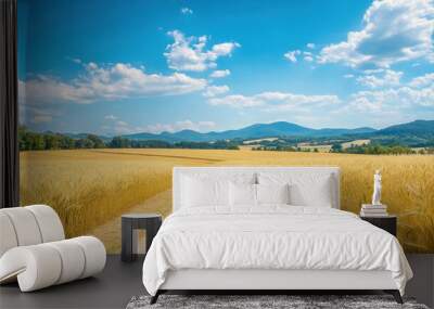 A scenic landscape featuring a dirt path through golden fields under a blue sky. Wall mural