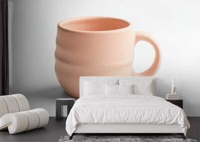 A simple, modern peach-colored ceramic mug with a textured design and handle. Wall mural