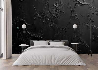 A textured black surface with a rough appearance, suitable for backgrounds or design elements. Wall mural