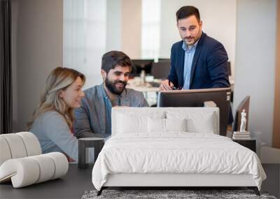 Business professionals collaborating on investments and teamwork, using a computer during a meeting, and working in partnership on the stock market. Wall mural