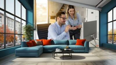 Business woman and man discussing project on desktop computer monitor screen at office Wall mural