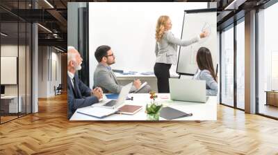 Confident team leader woman giving presentation to business partners in conference room Wall mural