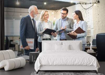 Group of business people discussing document during meeting in office Wall mural