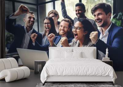 Group of happy business people celebrating success, raising hands with fist gesture at laptop in modern office. Wall mural