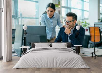 Male boss discussing online project with employee in the office Wall mural