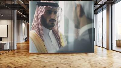 Portrait of confident Arab businessman in a meeting with business partner at modern office. Wall mural